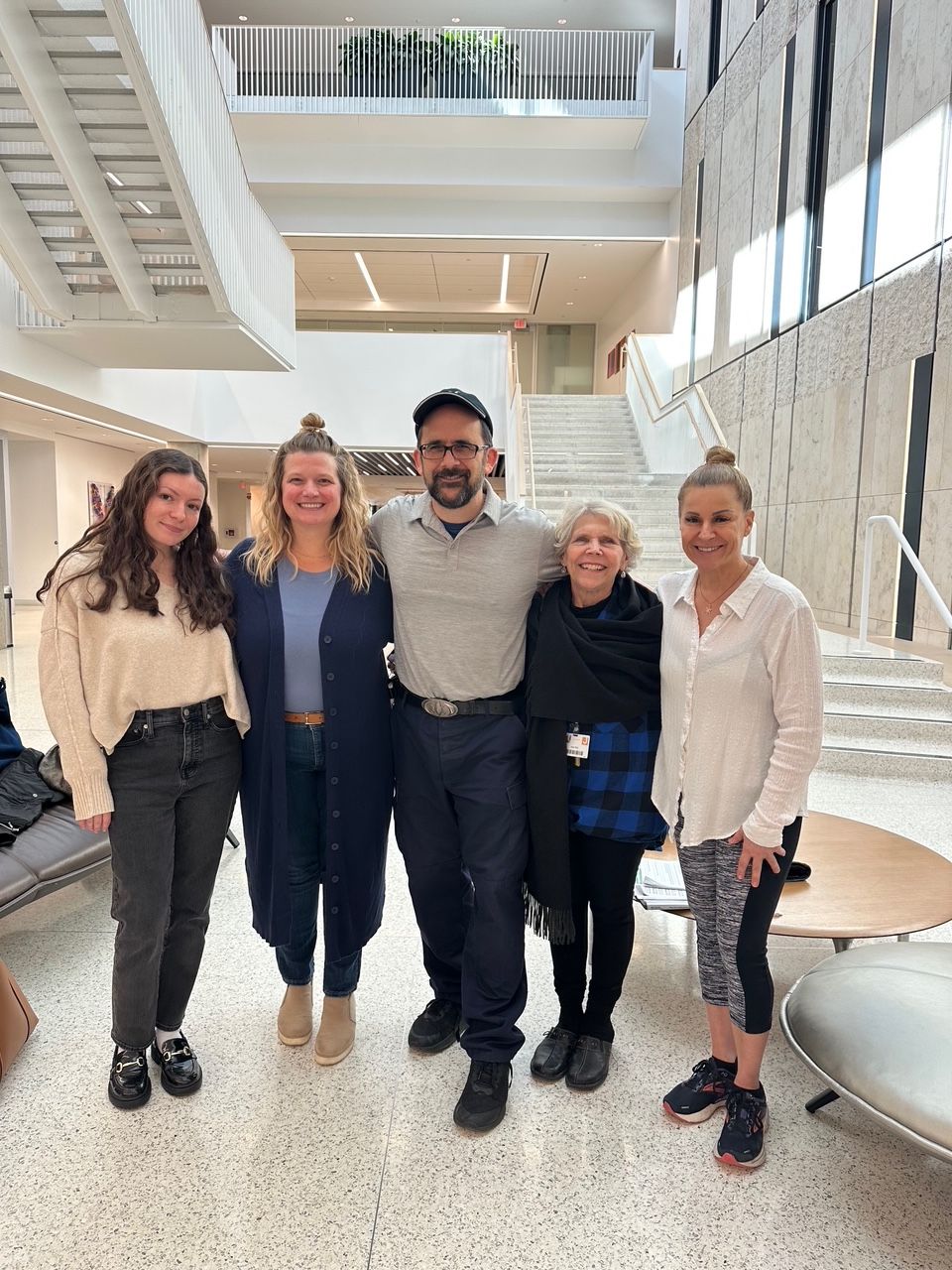 Marci with family at a hospital — a reminder of why this work matters